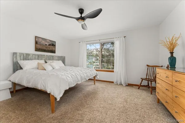 a spacious bedroom with a bed and a window