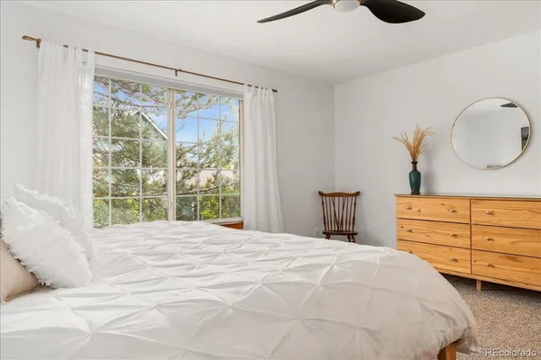 a bedroom with a large bed and a window