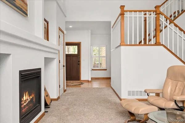 a view of a hallway with furniture and staircase
