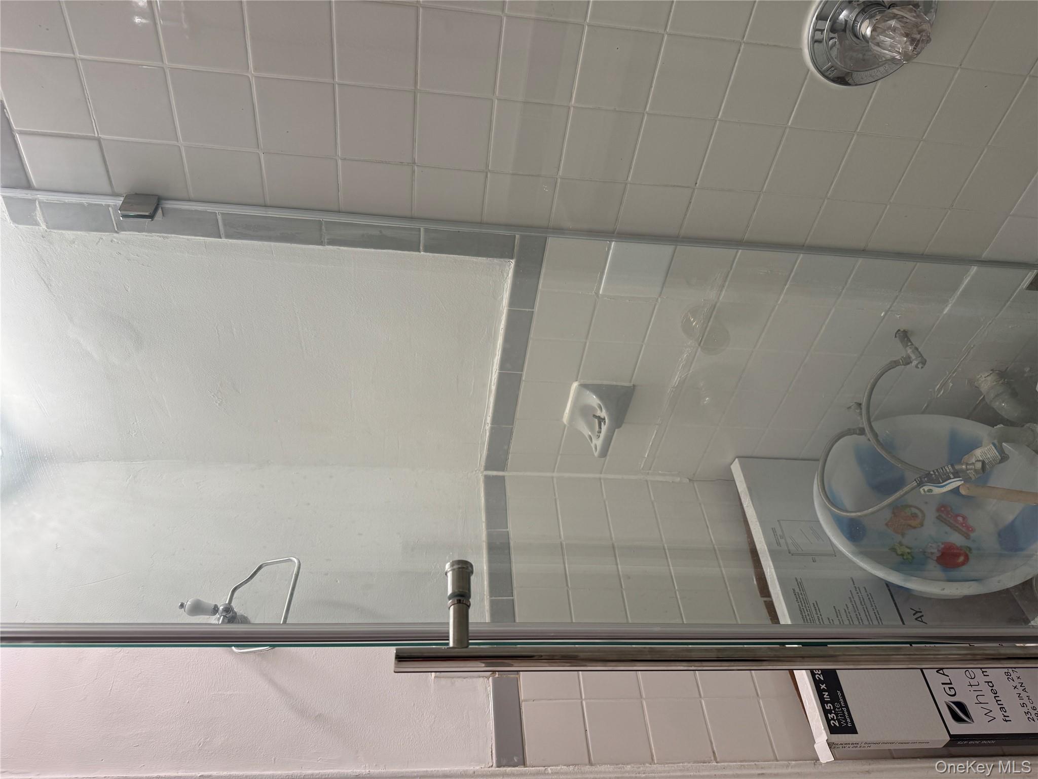 141-17 78th Road, Unit 1O Queens, NY 11367 - Photo 11 of 17 Bathroom with tile walls, washer / clothes dryer, and a tile shower