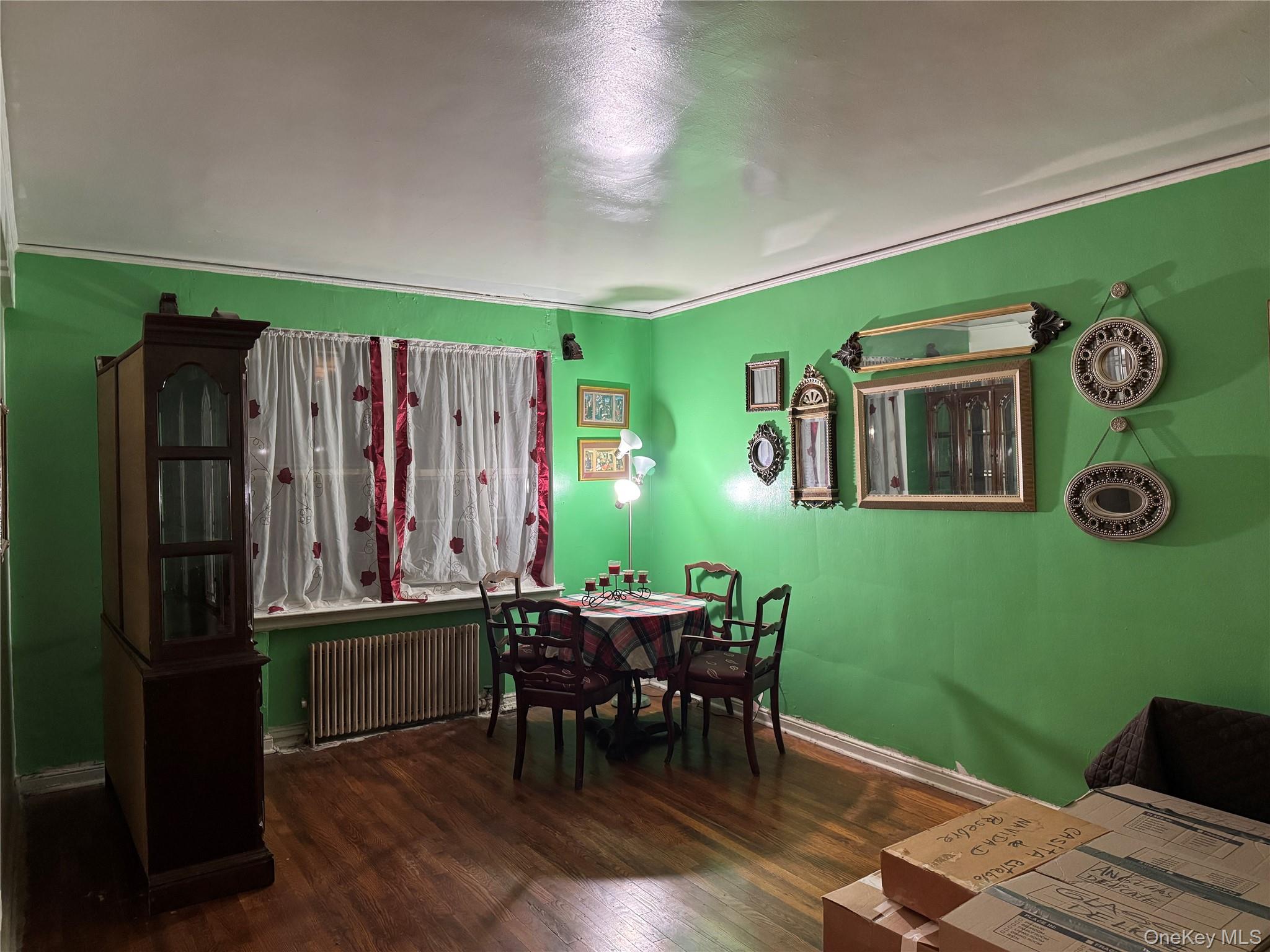 141-17 78th Road, Unit 1O Queens, NY 11367 - Photo 2 of 17 Dining area featuring radiator and wood finished floors