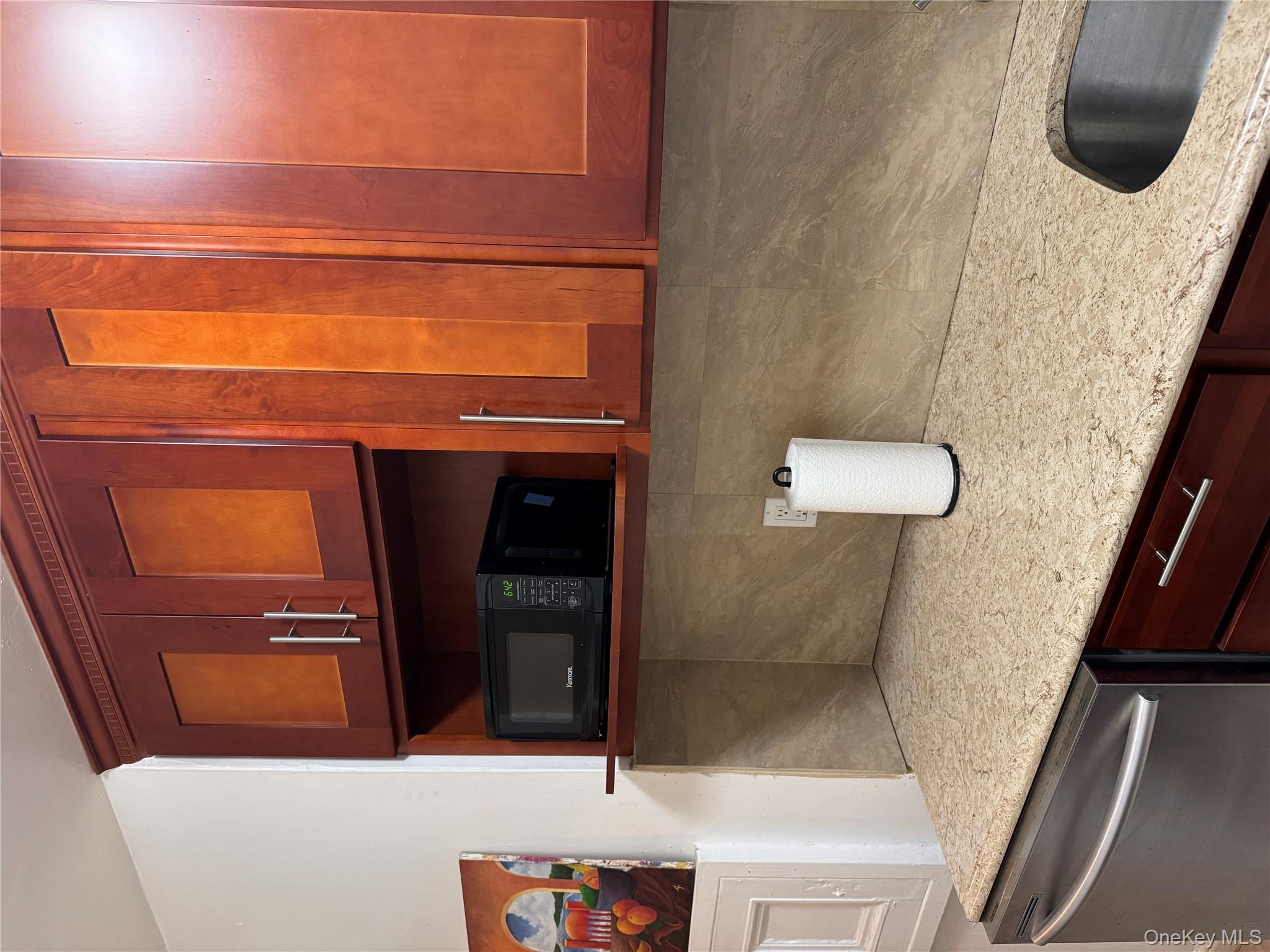 141-17 78th Road, Unit 1O Queens, NY 11367 - Photo 5 of 17 Kitchen with light stone countertops, white dishwasher, and tasteful backsplash