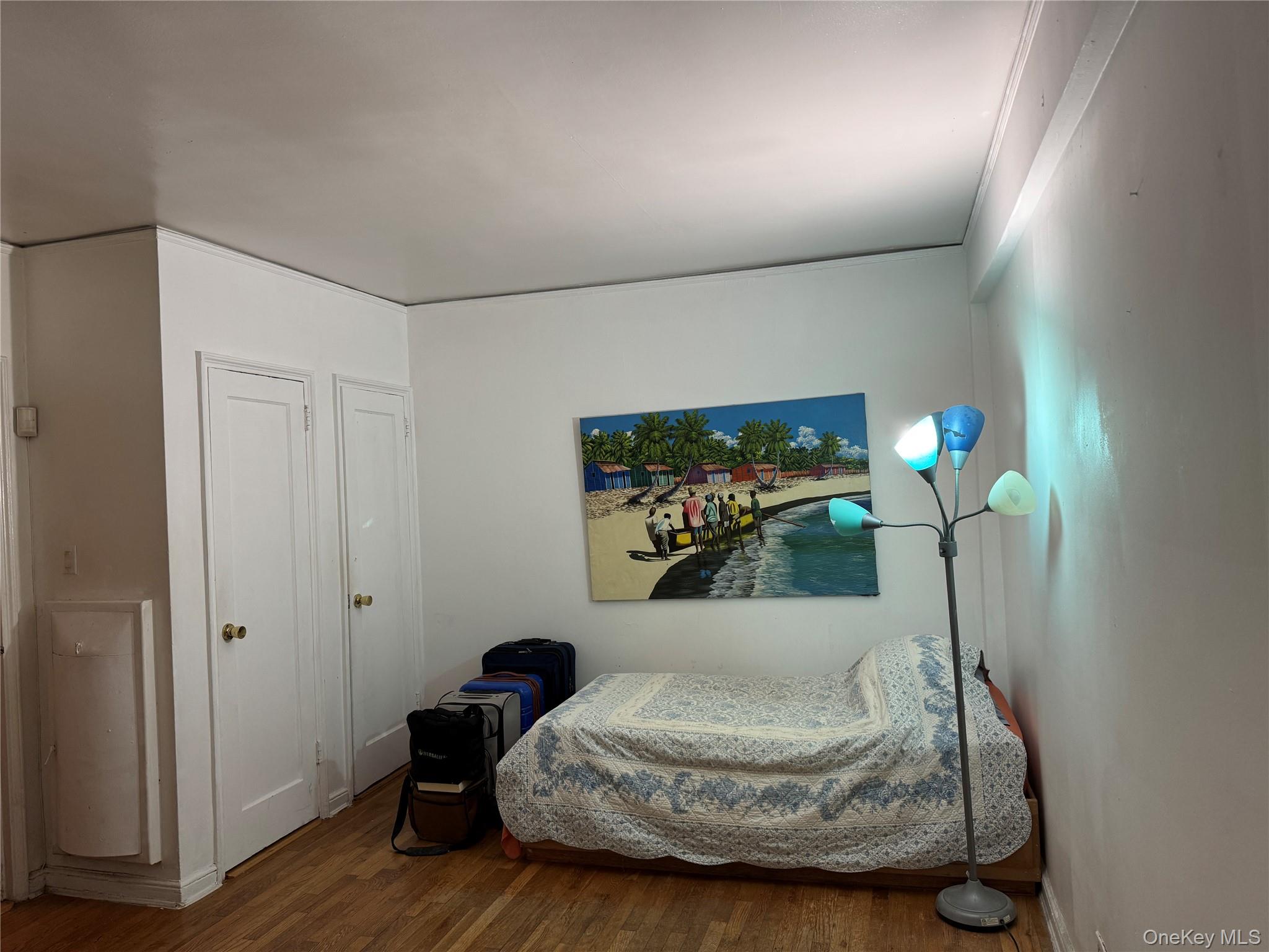 141-17 78th Road, Unit 1O Queens, NY 11367 - Photo 9 of 17 Bedroom featuring wood finished floors and baseboards