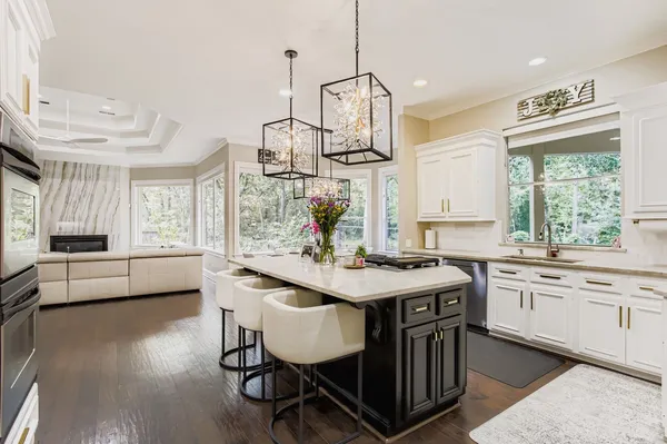 a kitchen with sink stove and wooden floor