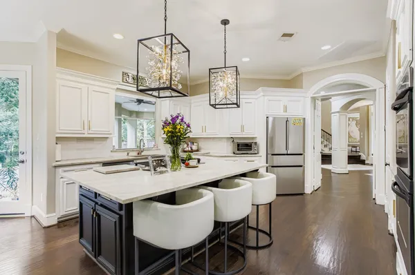 a kitchen with stainless steel appliances granite countertop a kitchen island a stove a table and chairs in it