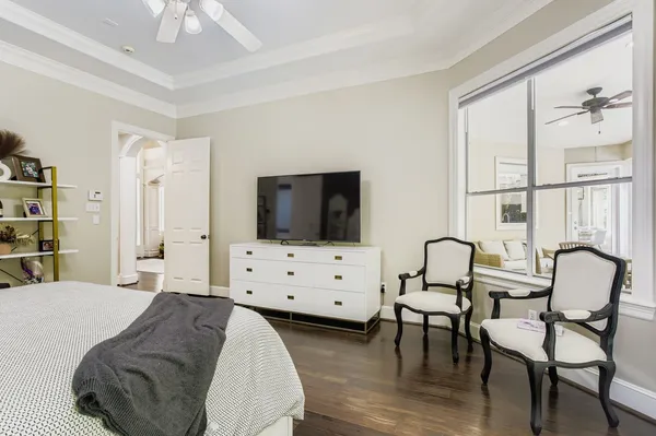 a bedroom with furniture and a flat screen tv