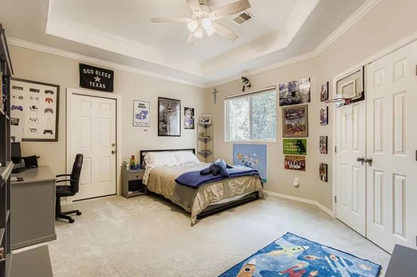 a spacious bedroom with a bed couch and a window