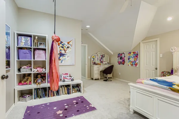 a bedroom with furniture and a book shelf