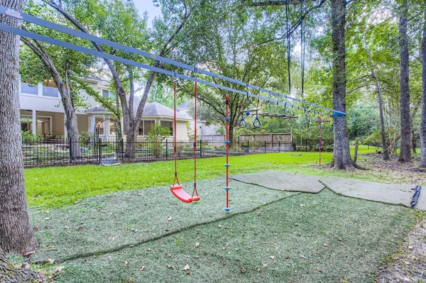 a view of a house with a backyard and a tree