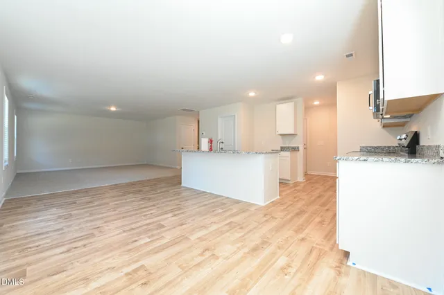 a kitchen with stainless steel appliances granite countertop a sink stove and cabinets