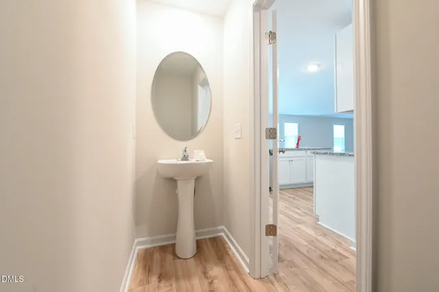 a spacious bedroom with a bed and a potted plant
