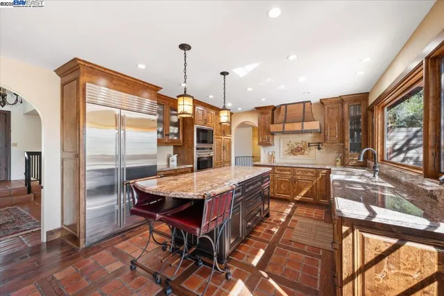 a very nice looking dining room with a large window and stainless steel appliances