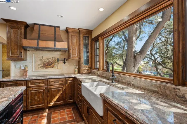 a kitchen that has a sink and a stove in it