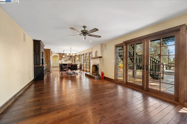 a view of a livingroom with furniture wooden floor to ceiling window and wooden floor