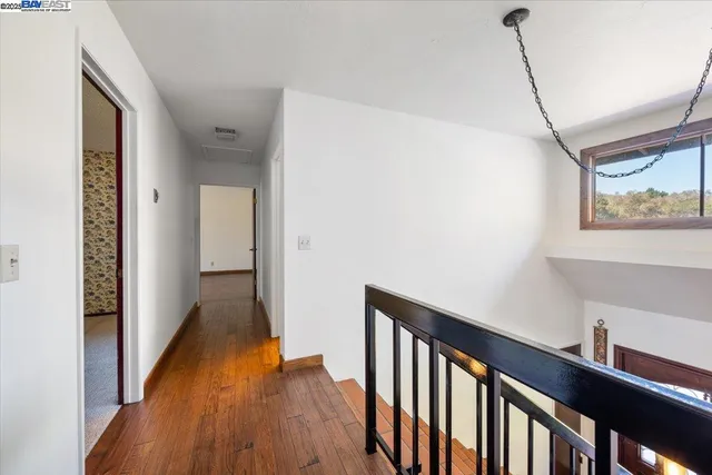 a view of hallway with wooden floor
