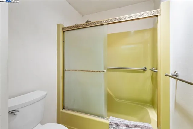a bathroom with a shower and a toilet