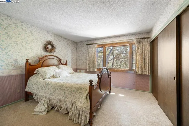 a bedroom with a bed and a large window