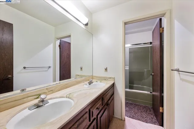 a bathroom with a sink a mirror and a shower