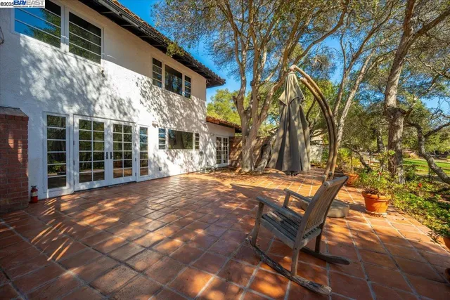 a view of a chairs and table in the backyard of the house