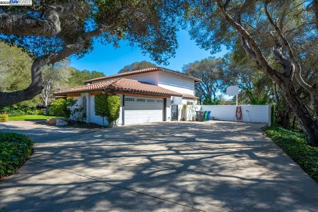 a view of a house with a yard and tree s