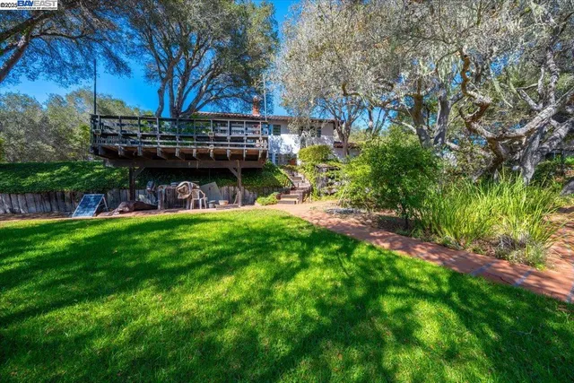 a view of a house with a yard and sitting area
