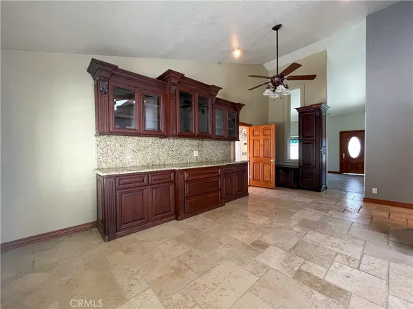 a kitchen with stainless steel appliances granite countertop a stove a sink and a wooden cabinets