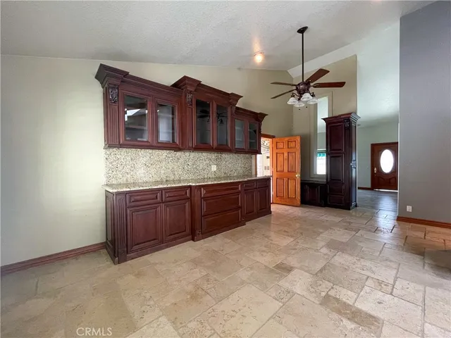 a kitchen with stainless steel appliances granite countertop a stove a sink and a wooden cabinets