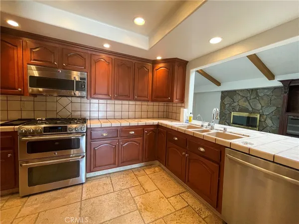 a kitchen with a sink stove and microwave