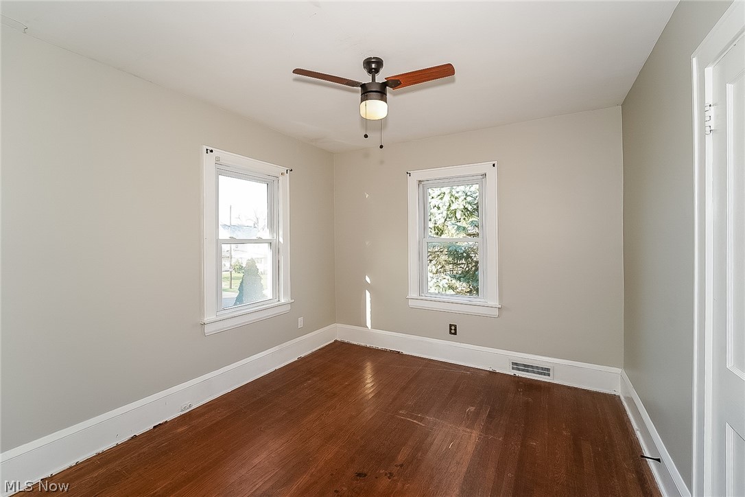 911 Dan Street Akron, OH 44310 - Photo 11 of 20 Empty room featuring a wealth of natural light, ceiling fan, and dark hardwood / wood-style floors