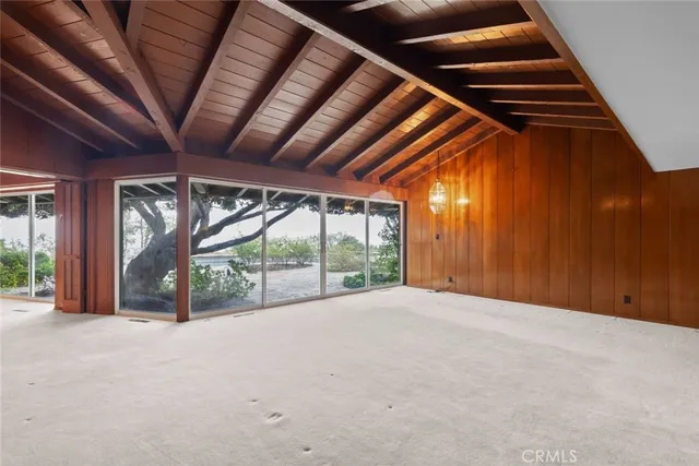 a view of an empty room with a fireplace and a fireplace
