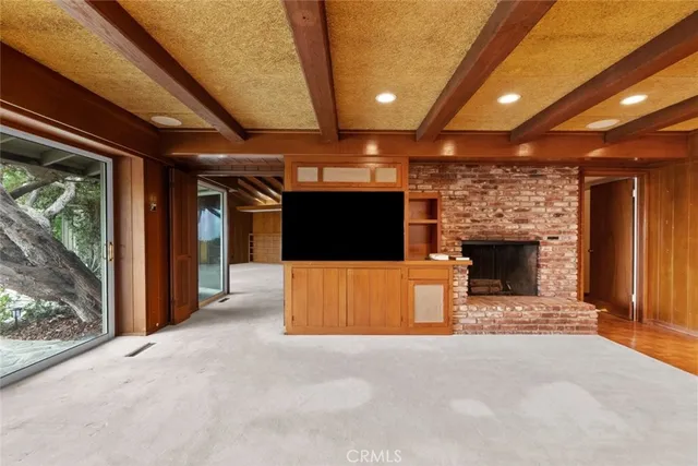 a view of a livingroom with furniture and a flat screen tv