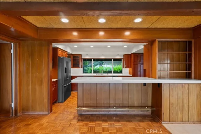 a kitchen with a stove a refrigerator and a sink