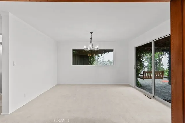 a kitchen with white cabinets and window