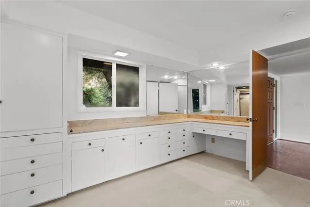 a bathroom with a granite countertop toilet and a shower