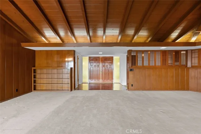 a view of an empty room with a fireplace and a window
