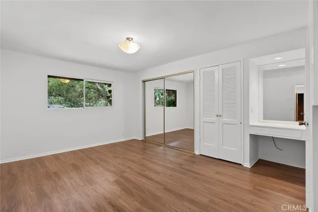 a view of house with yard and trees in the background