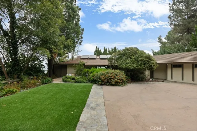 a backyard of a house with yard and outdoor seating