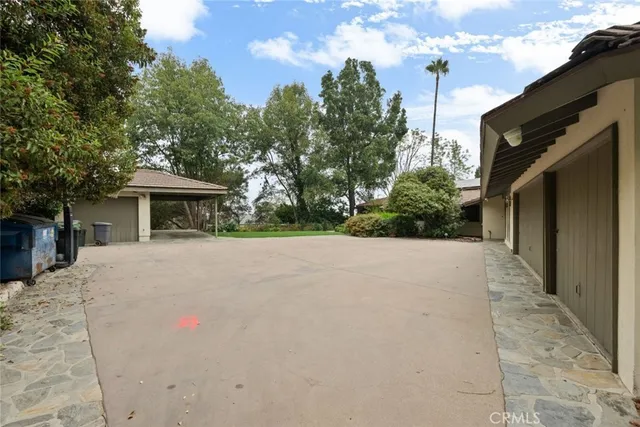 an aerial view of a house with a yard and large trees