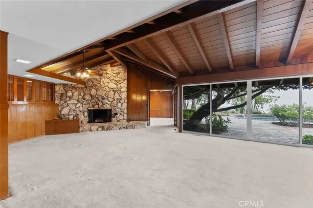 a view of a room with wooden walls and iron stairs