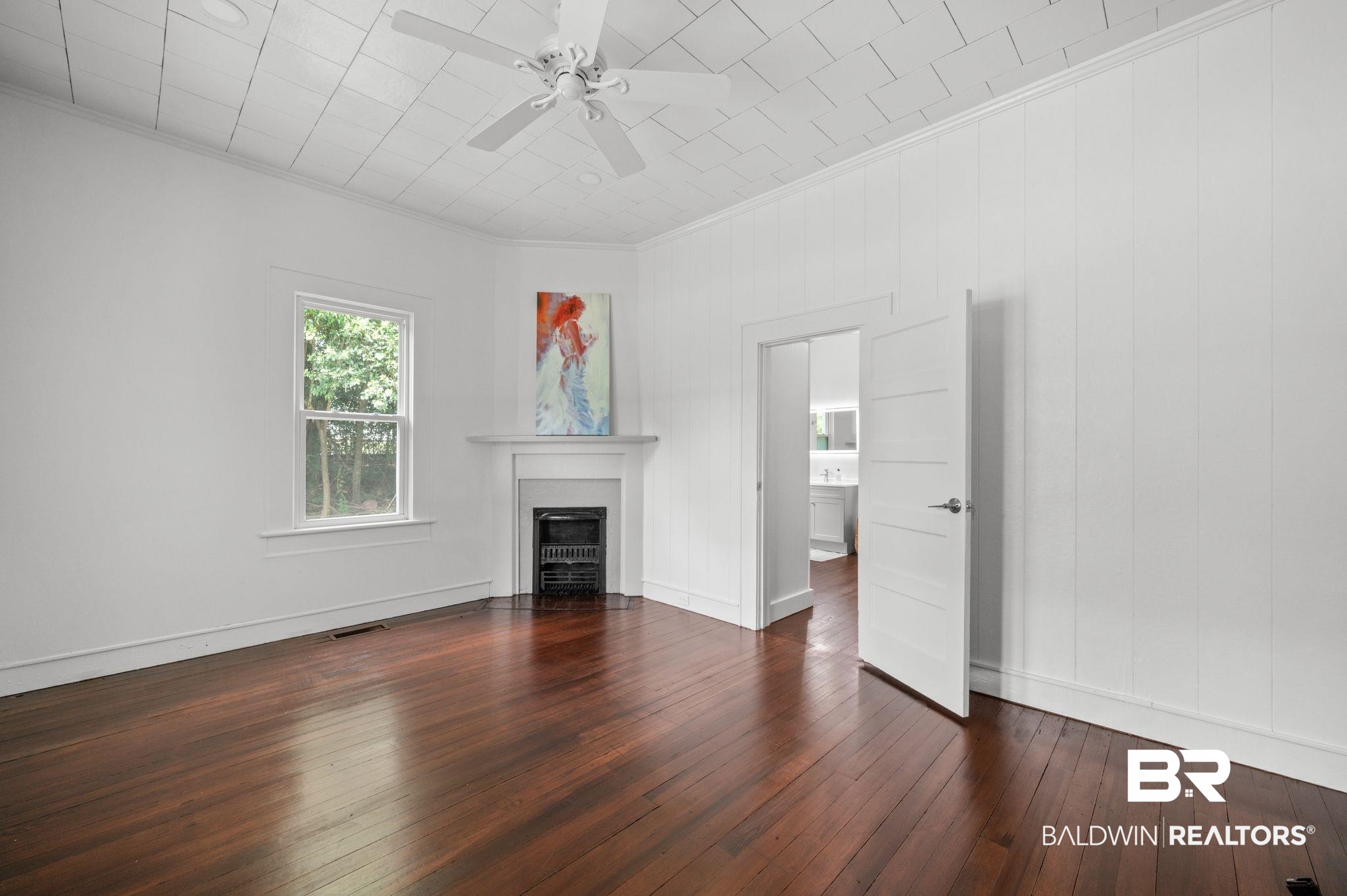 733 Pineville Road Monroeville, AL 36460 - Photo 10 of 68 Unfurnished living room with ceiling fan, crown molding, a fireplace with flush hearth, dark wood finished floors, and baseboards