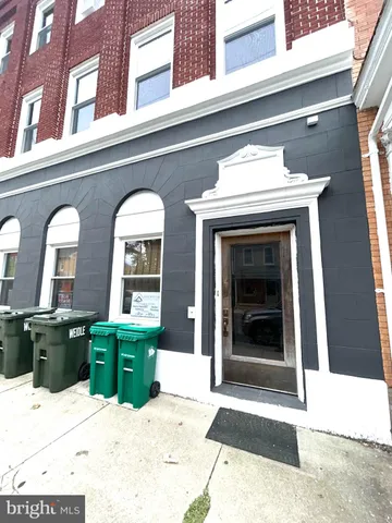 a view of front door of house with potted plant