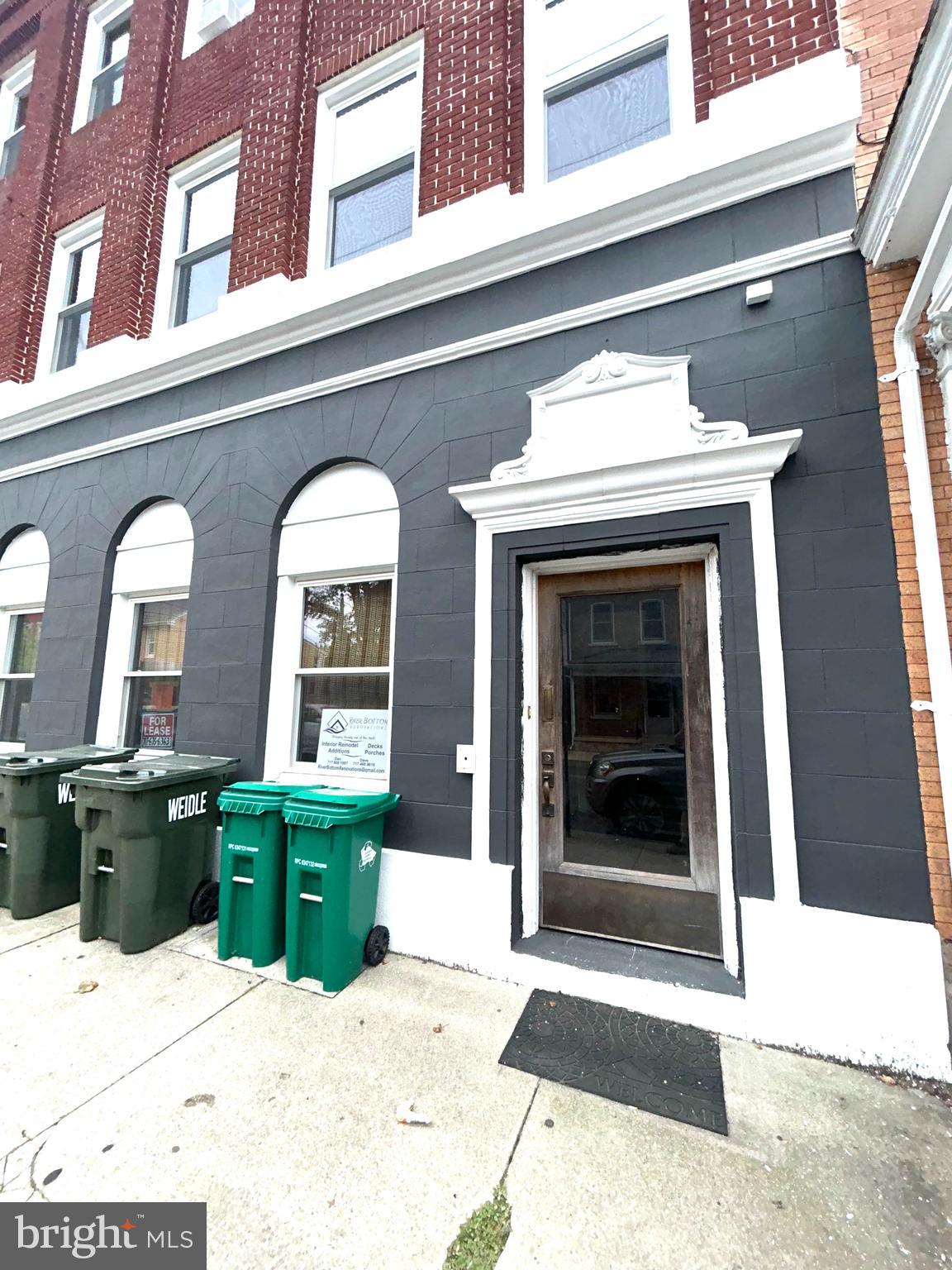 a view of front door of house with potted plant