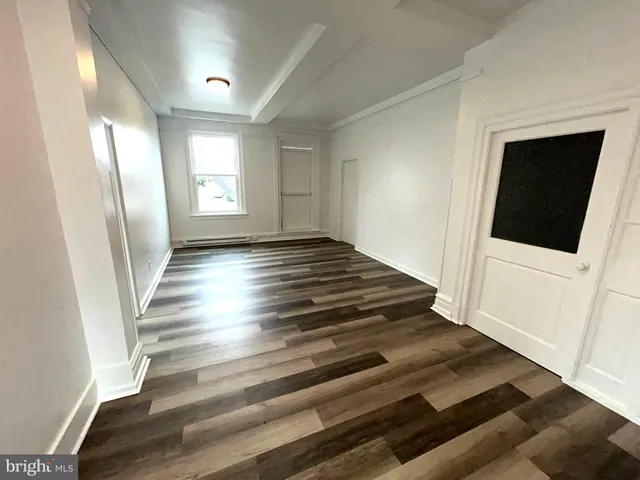 a view of an entryway with wooden floor