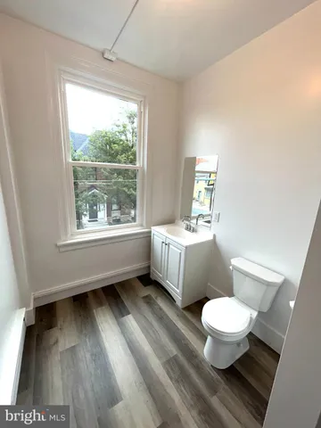 a white toilet sitting next to a bathroom sink