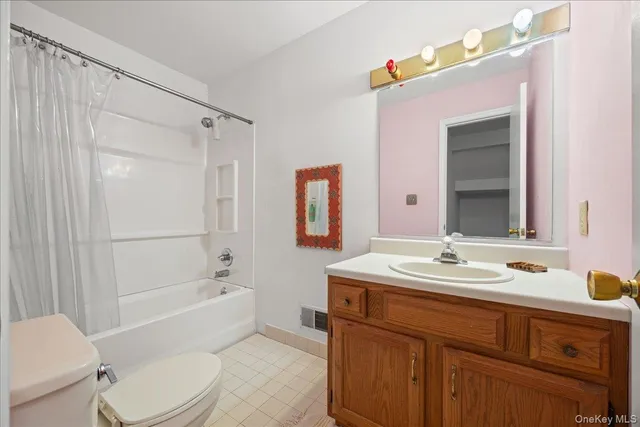 a bedroom with furniture and a flat screen tv