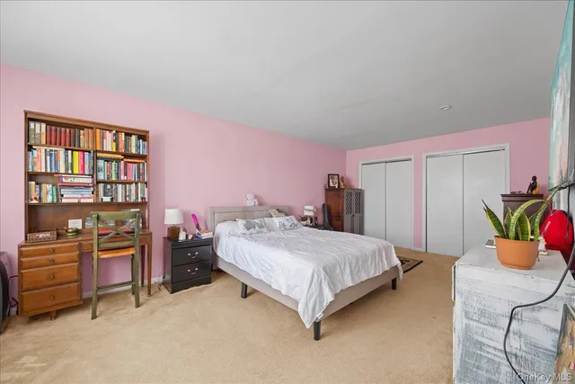 a bedroom with a bed and cabinets
