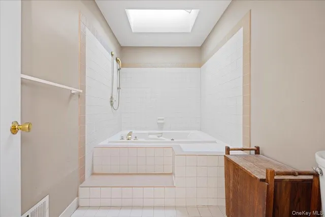 a spacious bathroom with a double vanity sink and a mirror