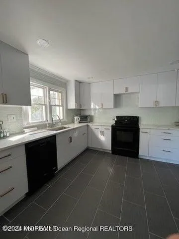 a large kitchen with cabinets and a stove