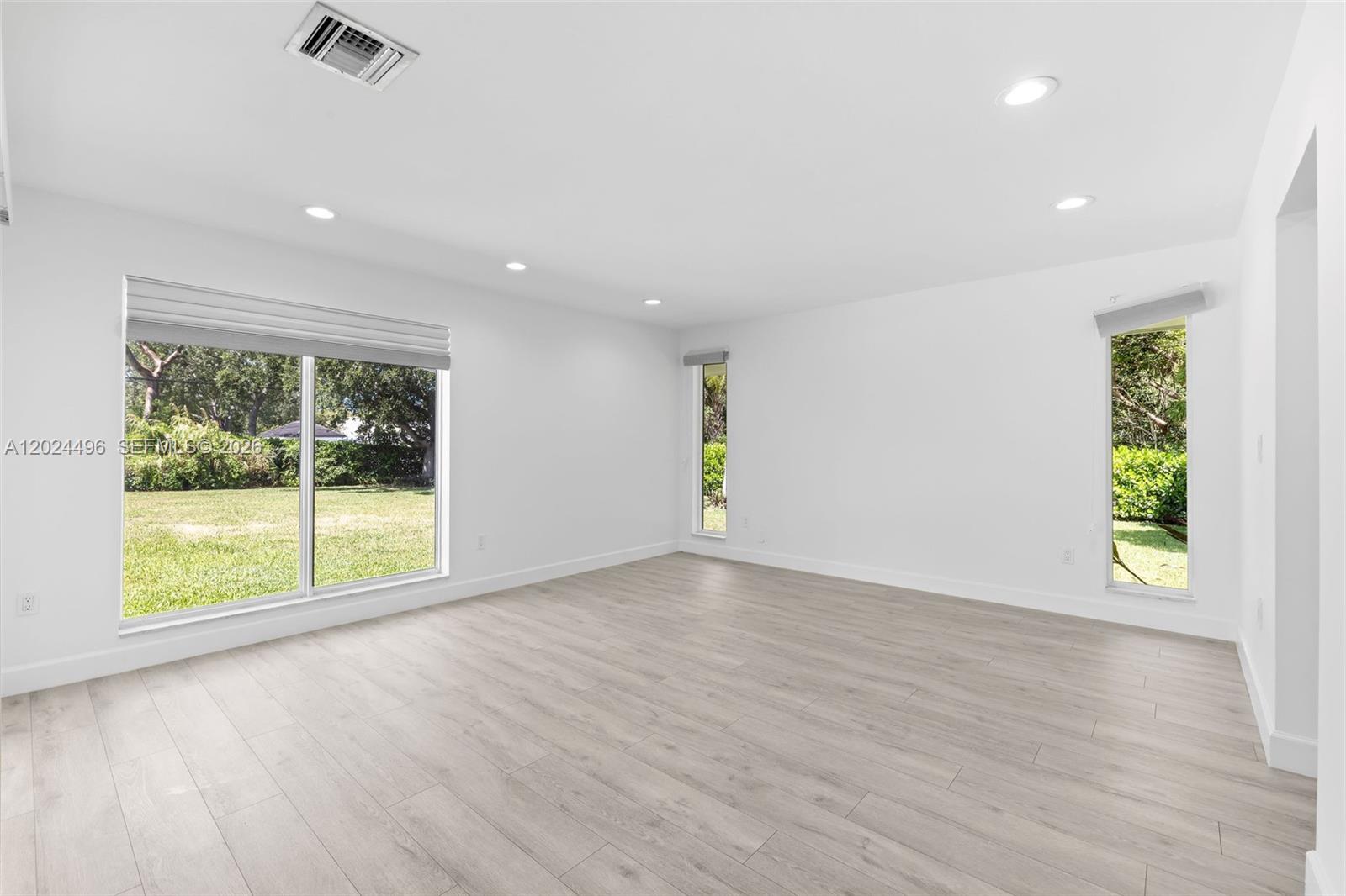 6875 North Cartee Road Palmetto Bay, FL 33158 - Photo 23 of 42 an empty room with wooden floor and windows