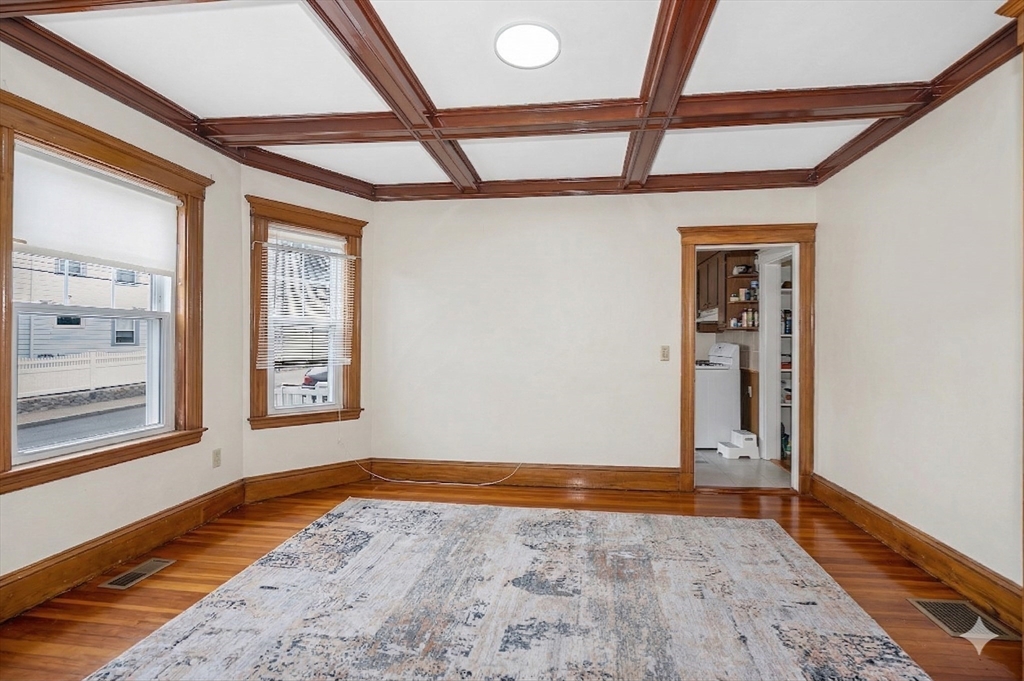 481 Lagrange Street Boston, MA 02132 - Photo 13 of 32 a view of an empty room with a window and wooden floor